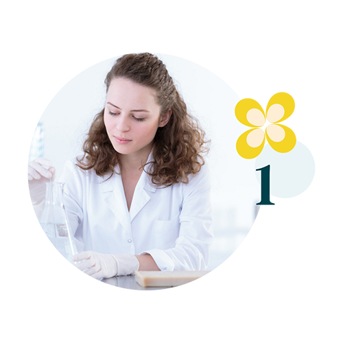 valeurs 1 Femme en blouse de laboratoire manipulant un bécher, assise à une paillasse dans un environnement scientifique lumineux, avec un élément graphique floral et le chiffre 1 sur la droite.